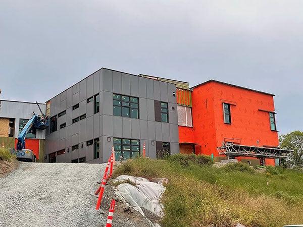 山上的一栋两层楼的建筑 -- half gray, half orange